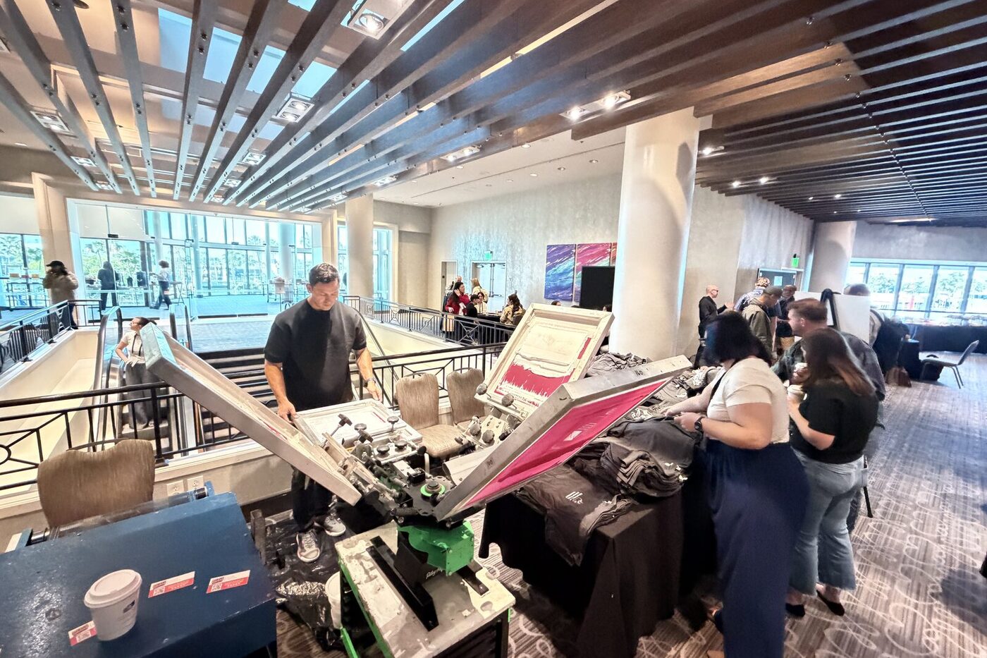Wide view of a live customization station on a busy conference mezzanine