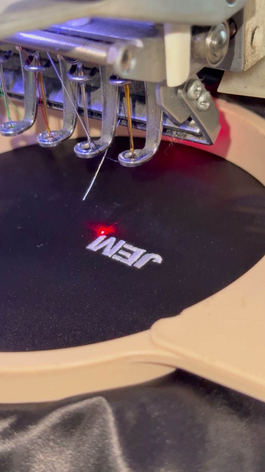 Freshly stitched embroidery inside the hoop at a live event station